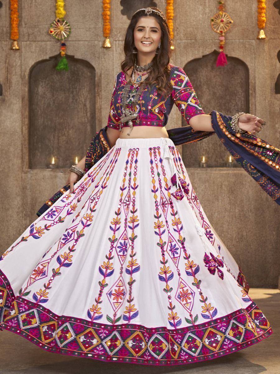Woman in colorful embroidered lehenga choli with mirror work, perfect for Indian ethnic occasions