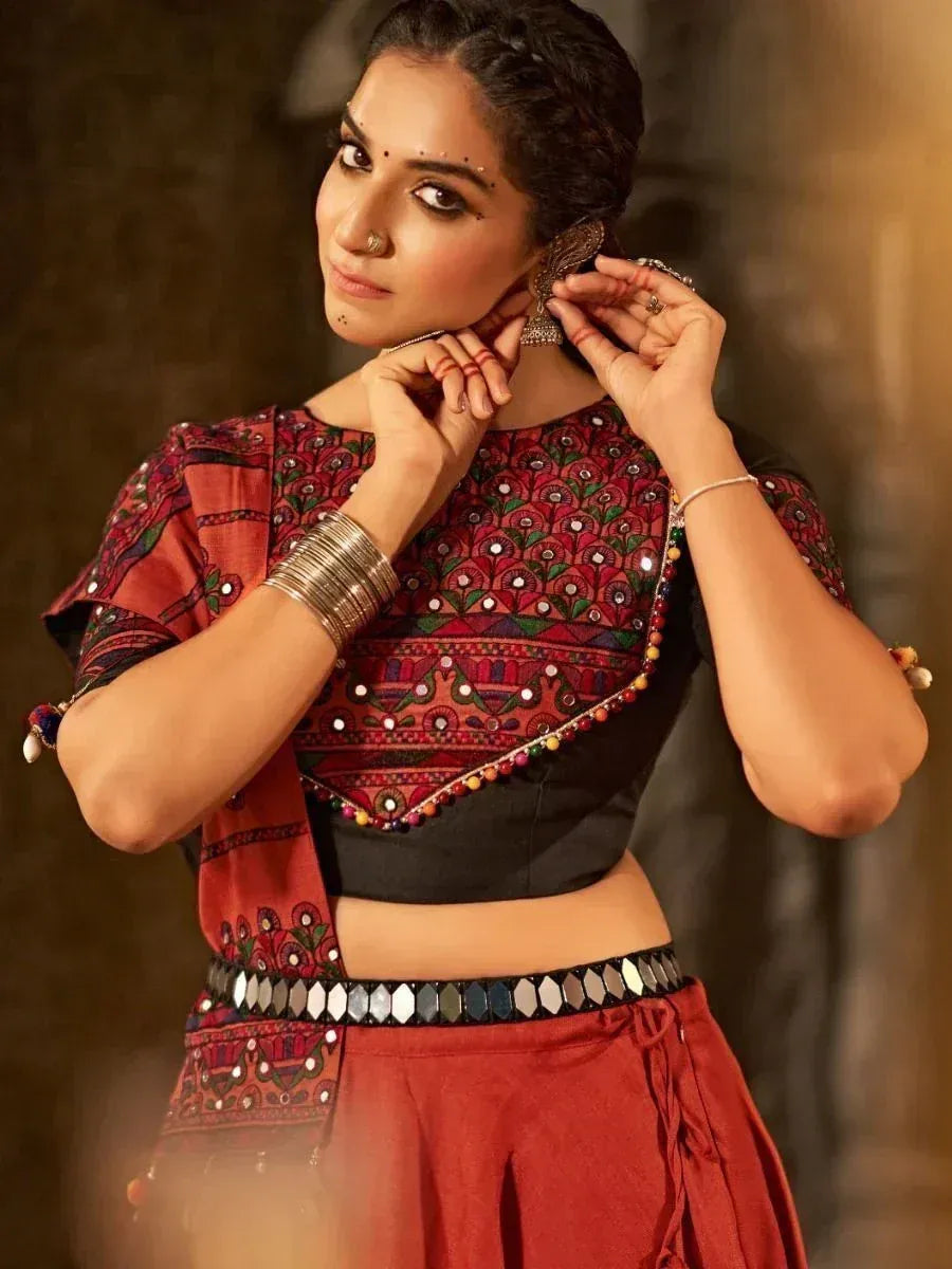 Woman in red embroidered ethnic top and skirt with mirror work, traditional Indian attire