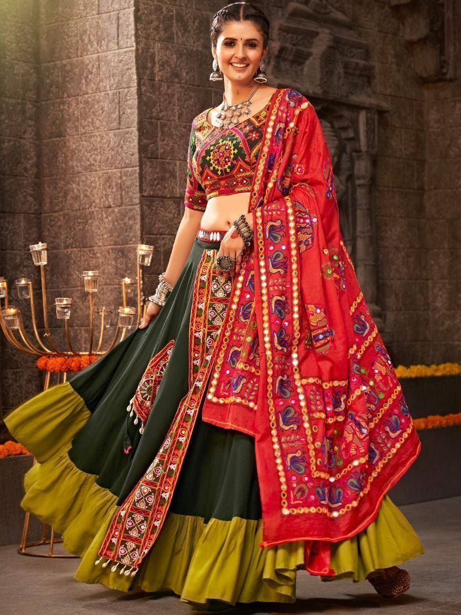 Vibrant red and green embroidered lehenga choli with mirror work, perfect for Indian ethnic occasions
