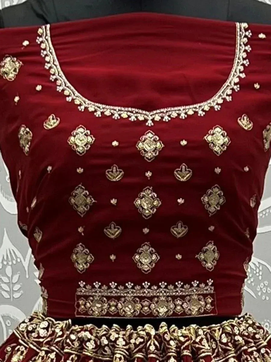 Maroon velvet lehenga choli with gold embroidery, perfect for Indian ethnic wear and festive occasions.