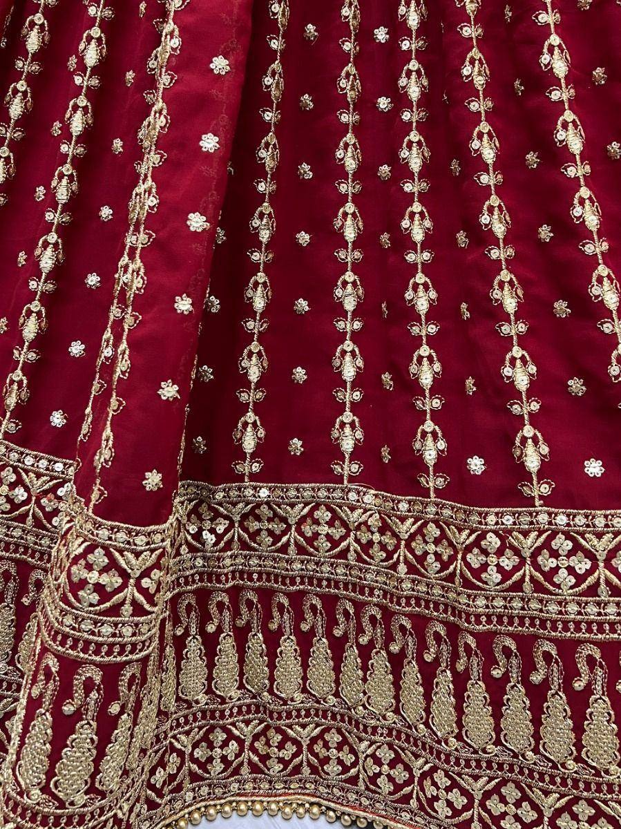 Rich maroon lehenga with intricate gold embroidery and floral motifs, perfect for Indian ethnic wear