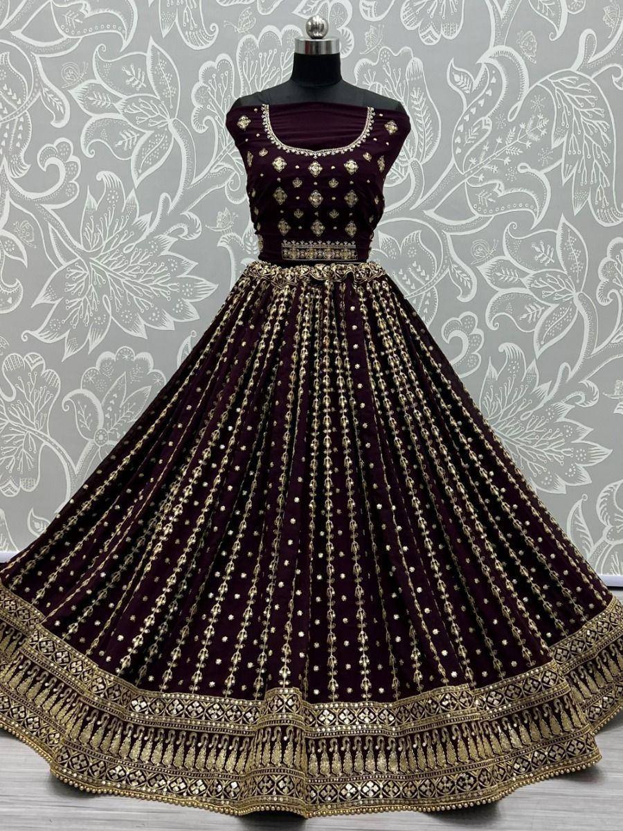 Elegant maroon lehenga choli with gold embroidery, perfect for Indian weddings and festive occasions.