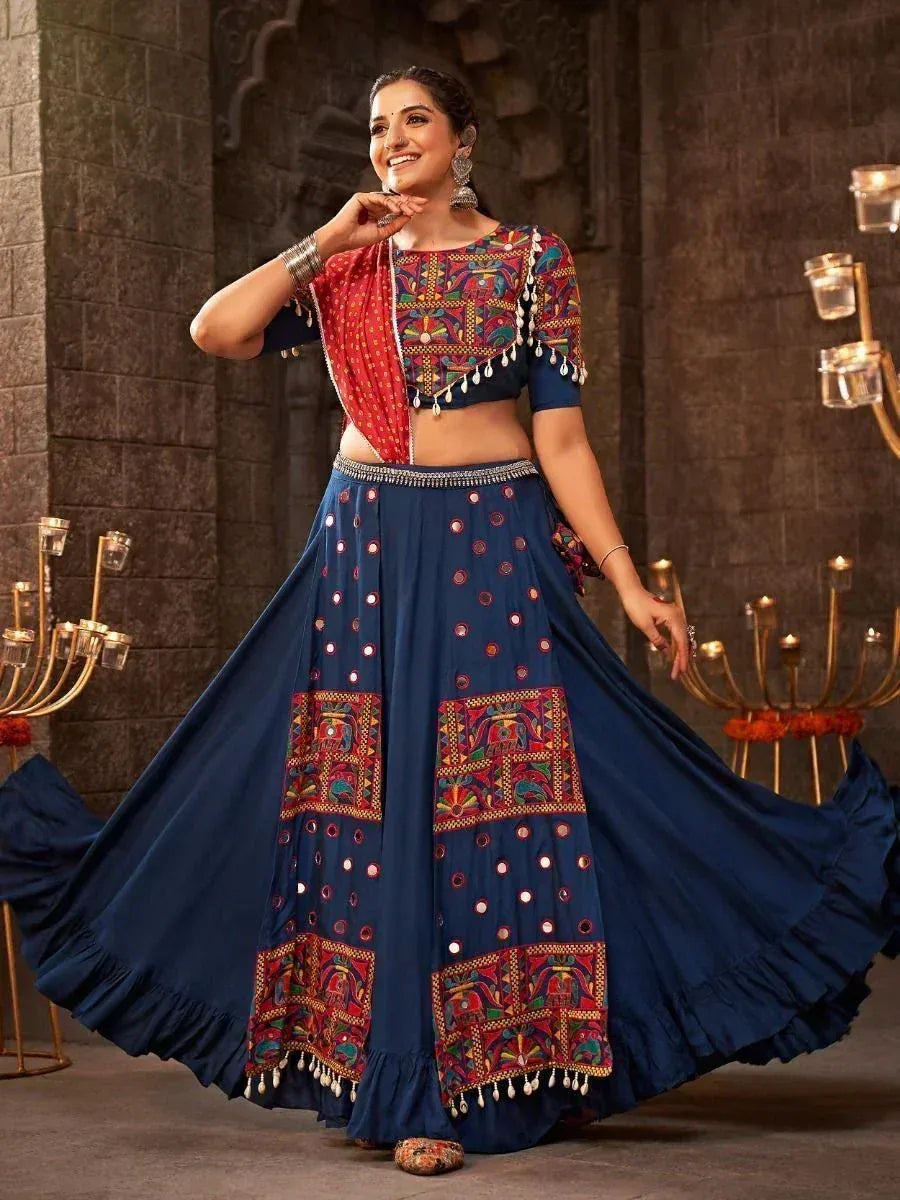 Woman in blue embroidered lehenga choli with mirror work, perfect for Indian ethnic occasions