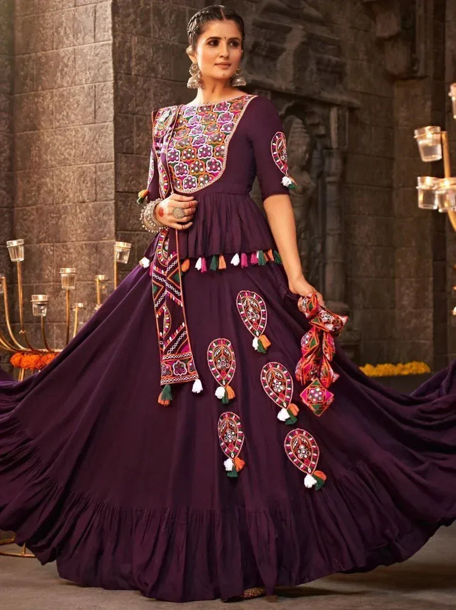 Purple ethnic gown with colorful embroidery and tassels, perfect for Indian festive occasions