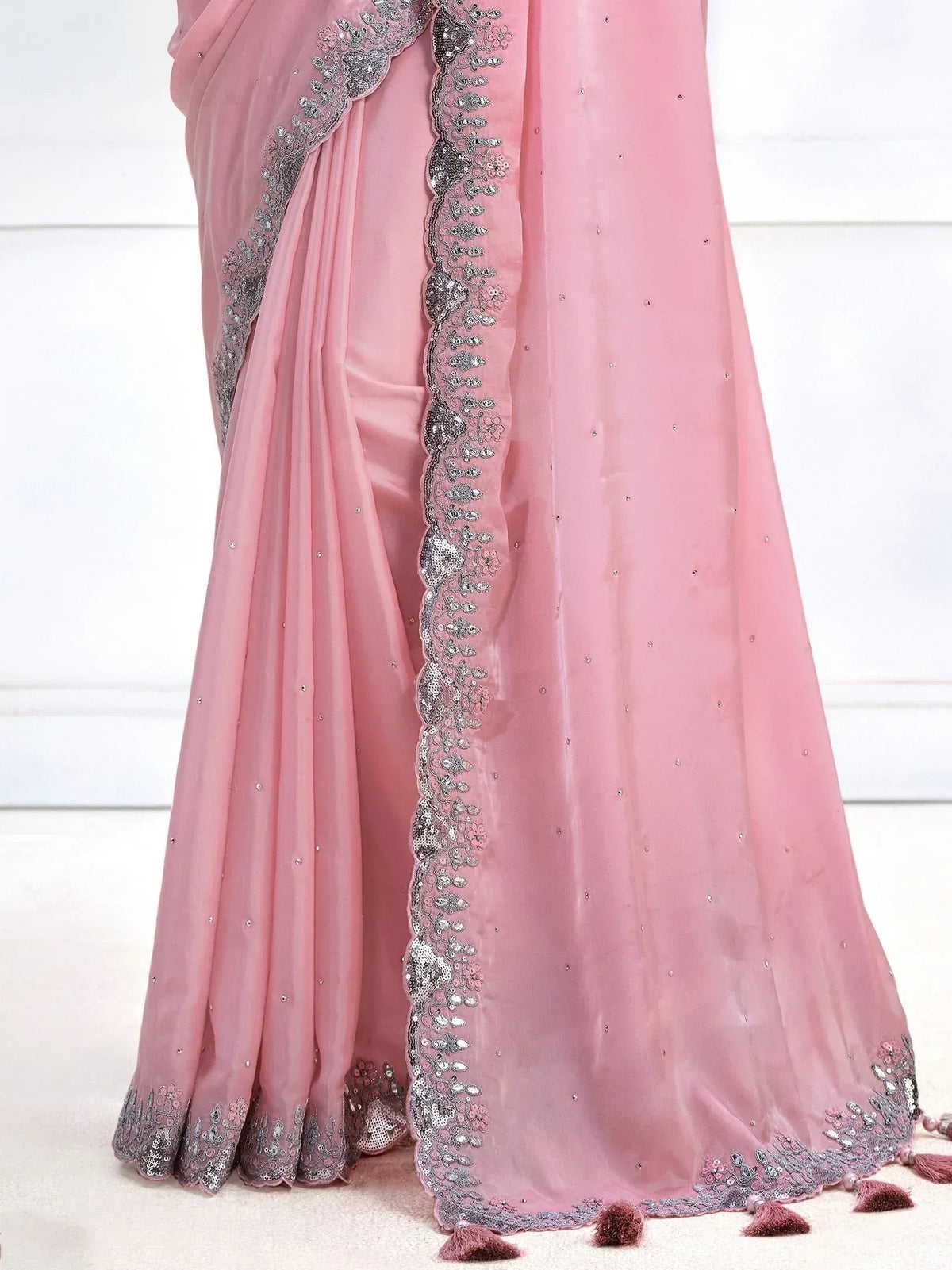 Pink designer saree with silver embroidery, sequins, and tassels for ethnic wear