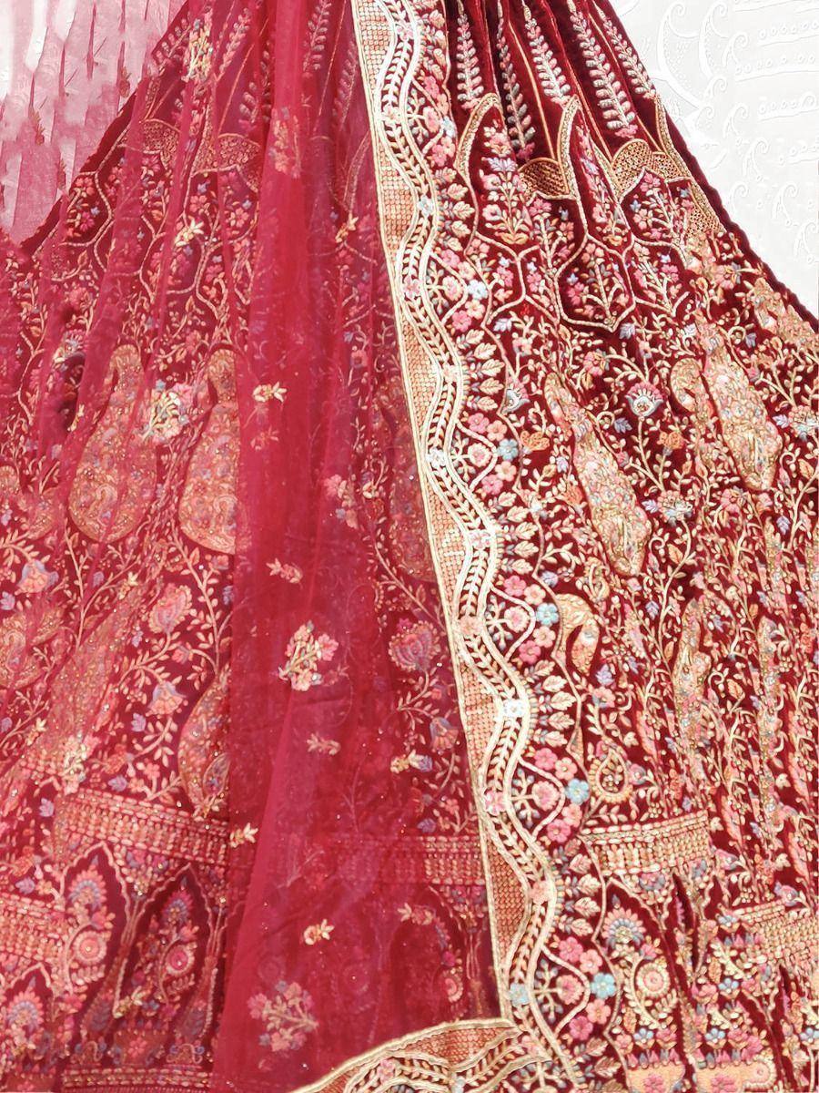 Rich maroon lehenga with intricate gold floral embroidery and sheer dupatta, perfect for Indian weddings.