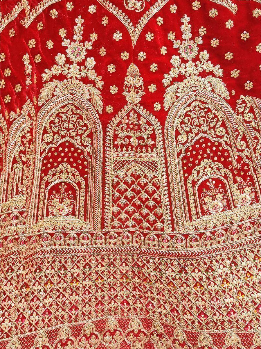 Red velvet lehenga with gold floral and arch embroidery, perfect for Indian weddings and festive occasions.