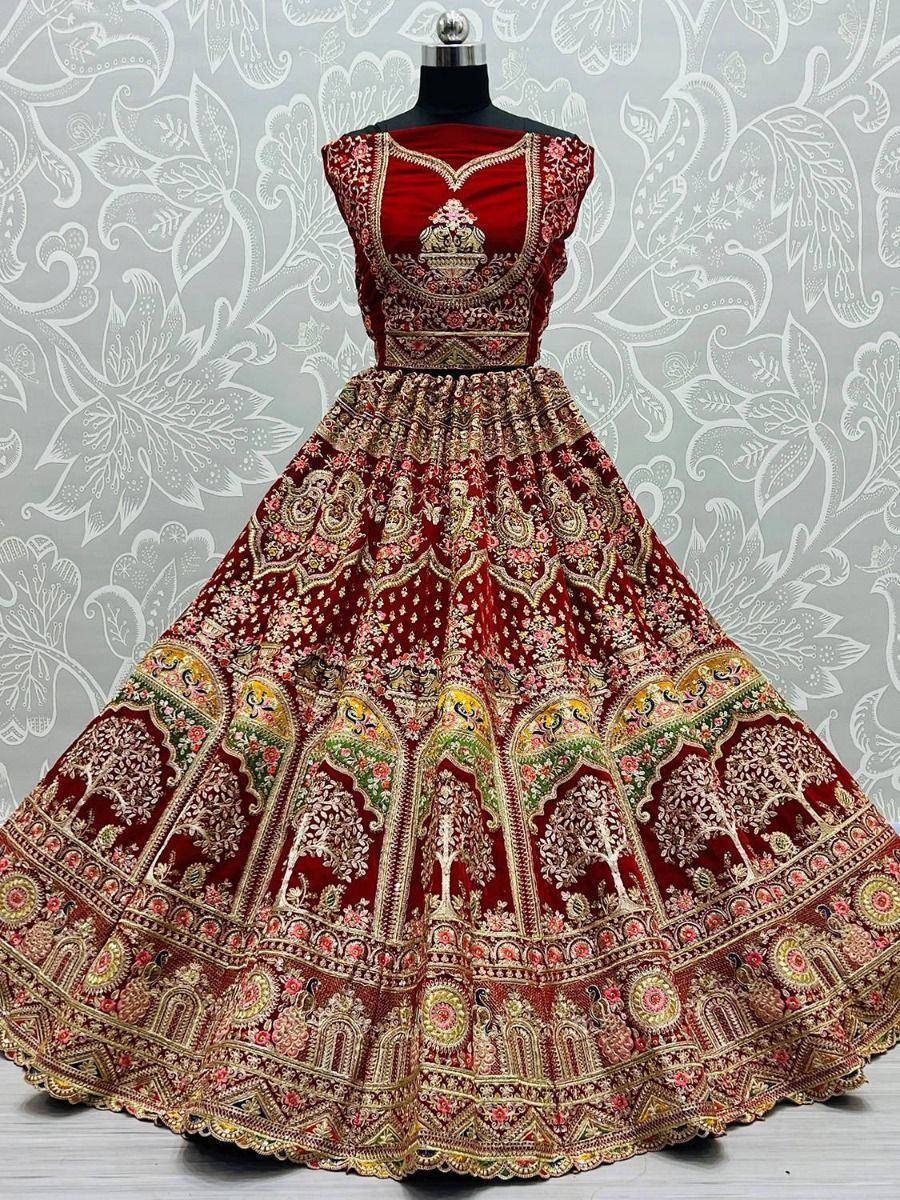Red embroidered lehenga choli with intricate gold and floral patterns, perfect for Indian ethnic wear occasions.
