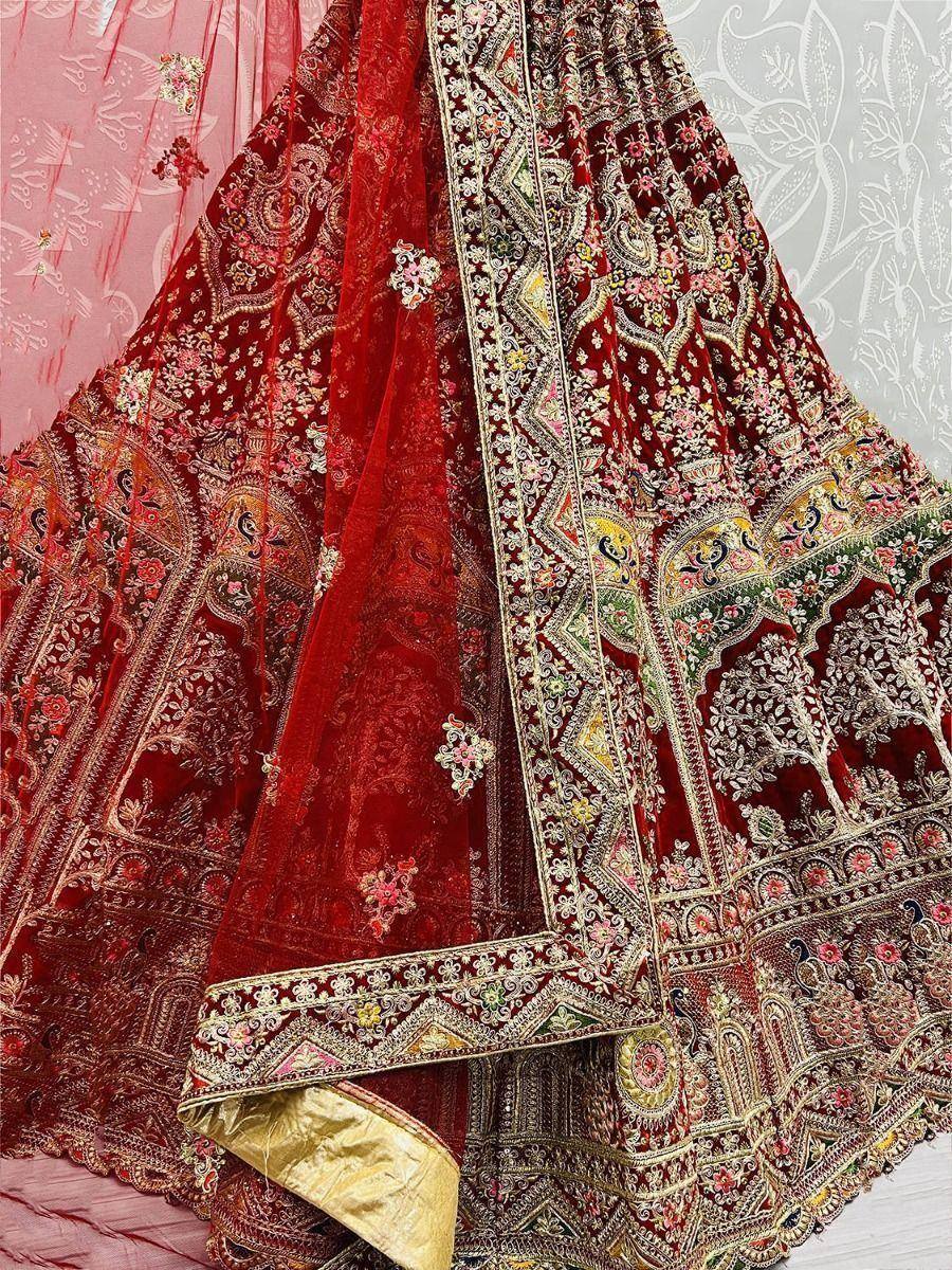 Red velvet lehenga choli with intricate gold embroidery and floral motifs, perfect for Indian weddings