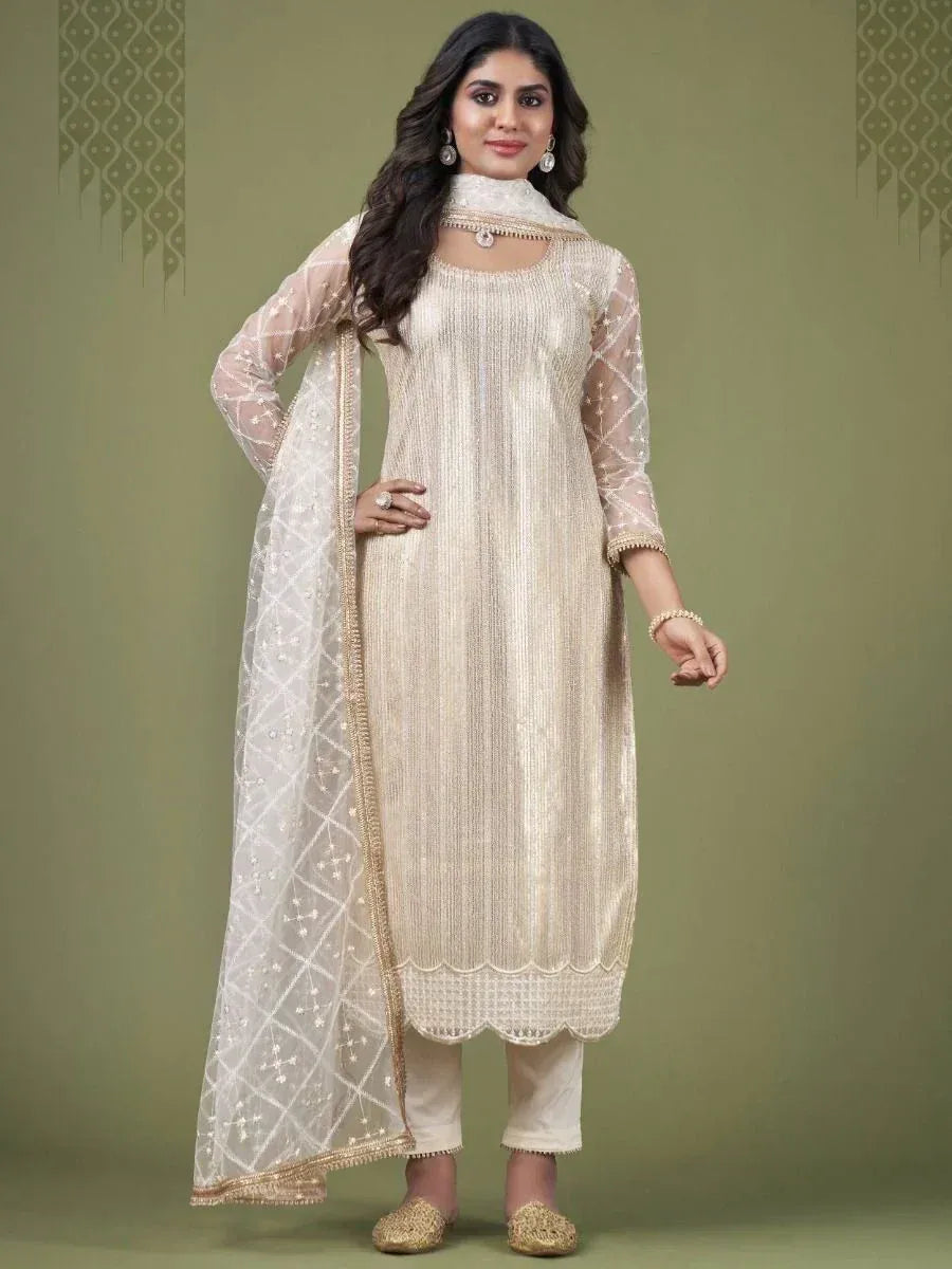 Woman wearing cream embroidered straight salwar kameez with sheer dupatta and gold juttis