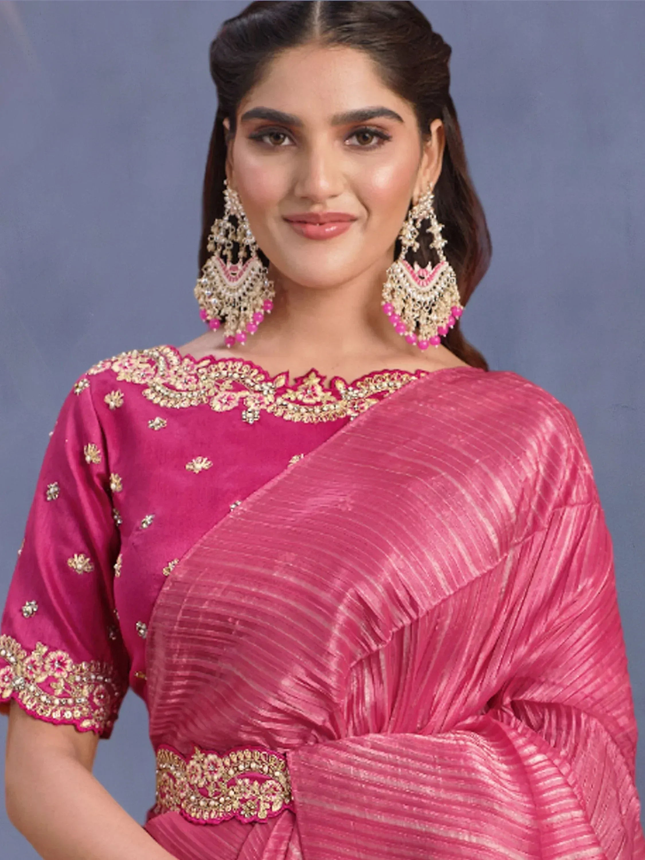 Lavender ethnic gown with sequin embroidery, sheer sleeves, and matching accessories for Indian occasions.