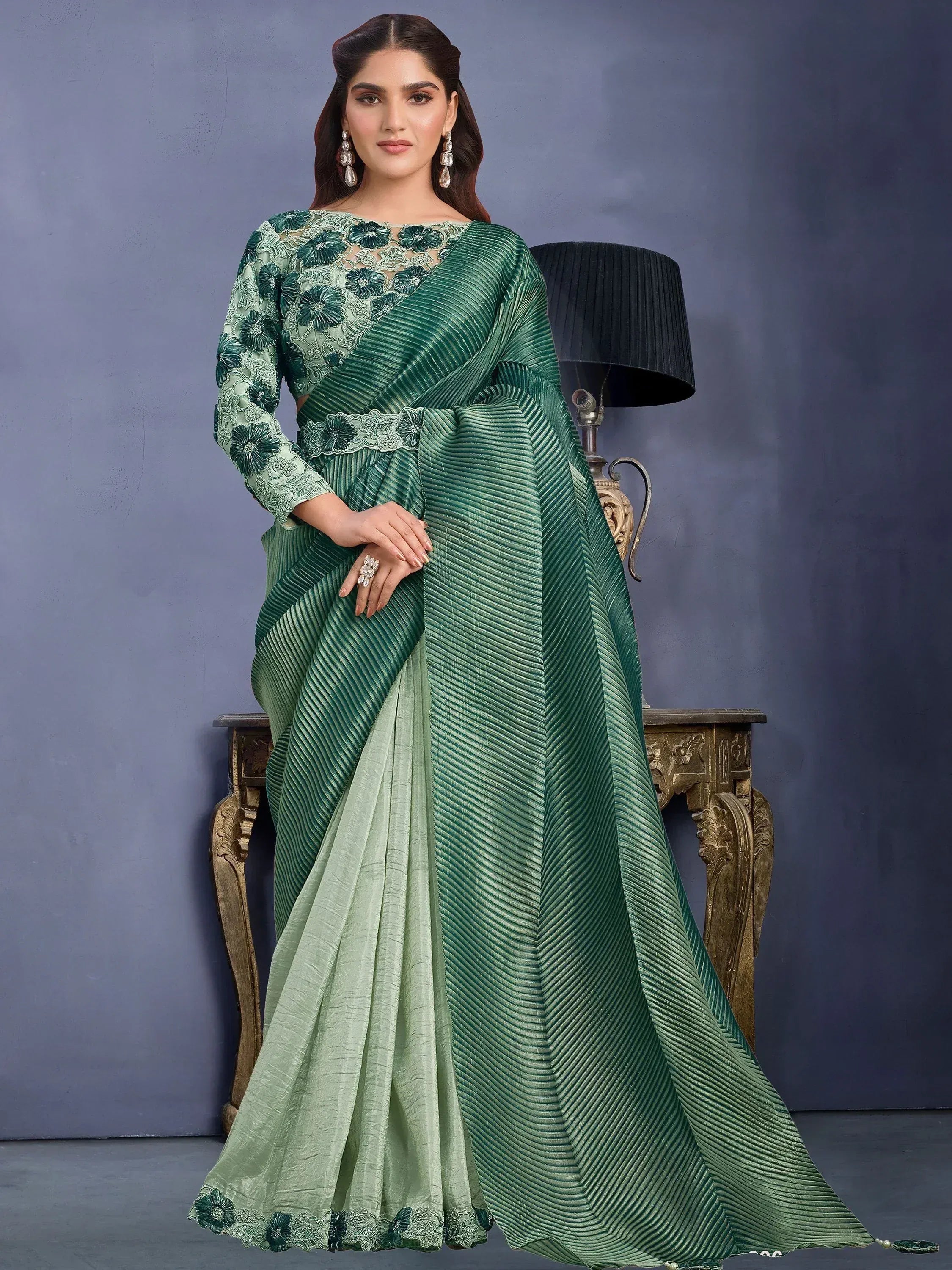 Emerald green designer saree with floral embroidery and pleated texture, perfect for ethnic occasions