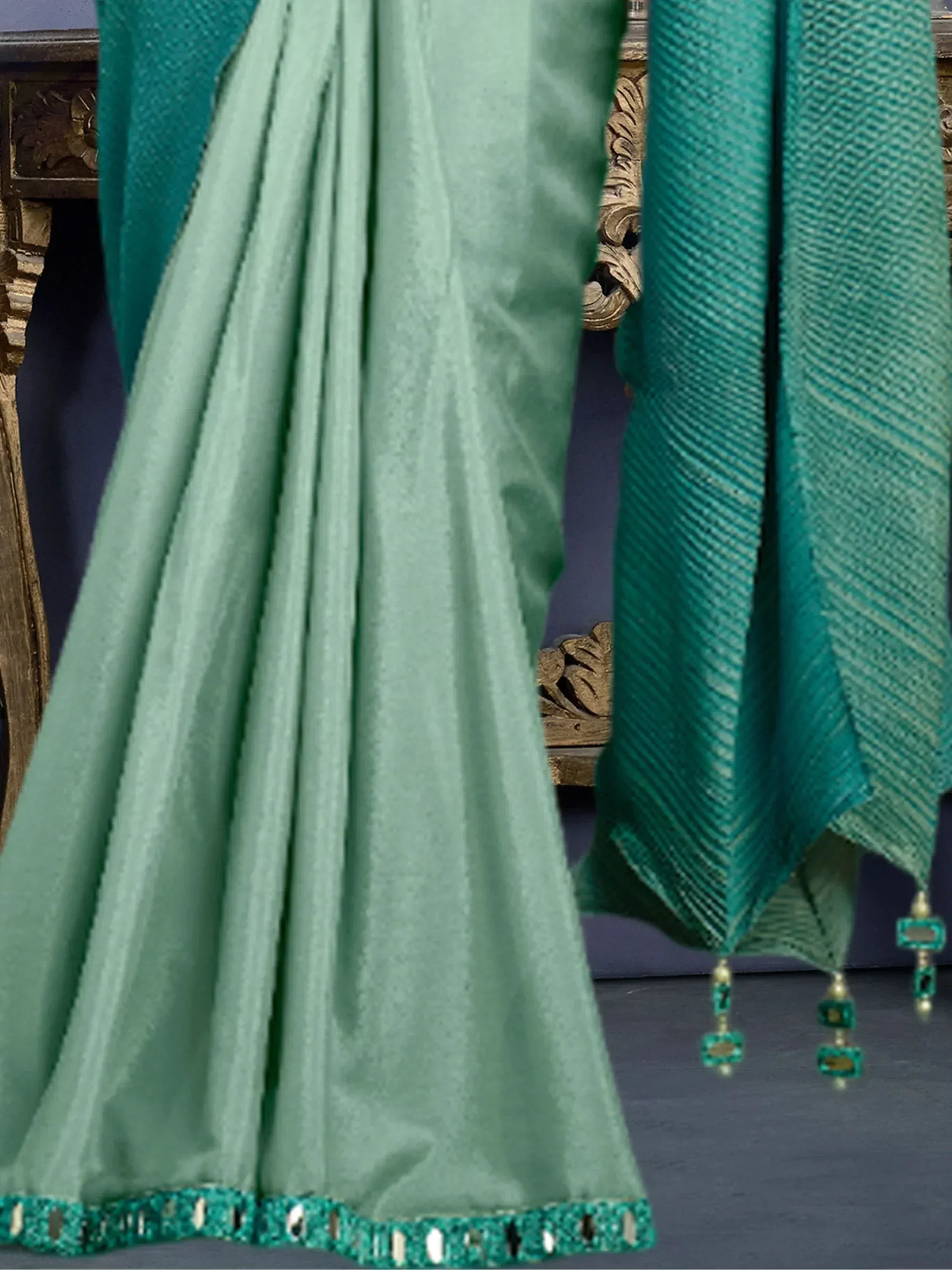 Mint green lehenga with teal dupatta, mirror work border, and tassels for Indian ethnic wear