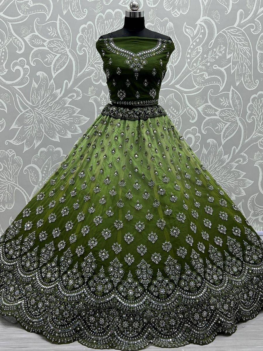 Emerald green designer lehenga choli with heavy stone embroidery, perfect for Indian weddings and festive occasions.