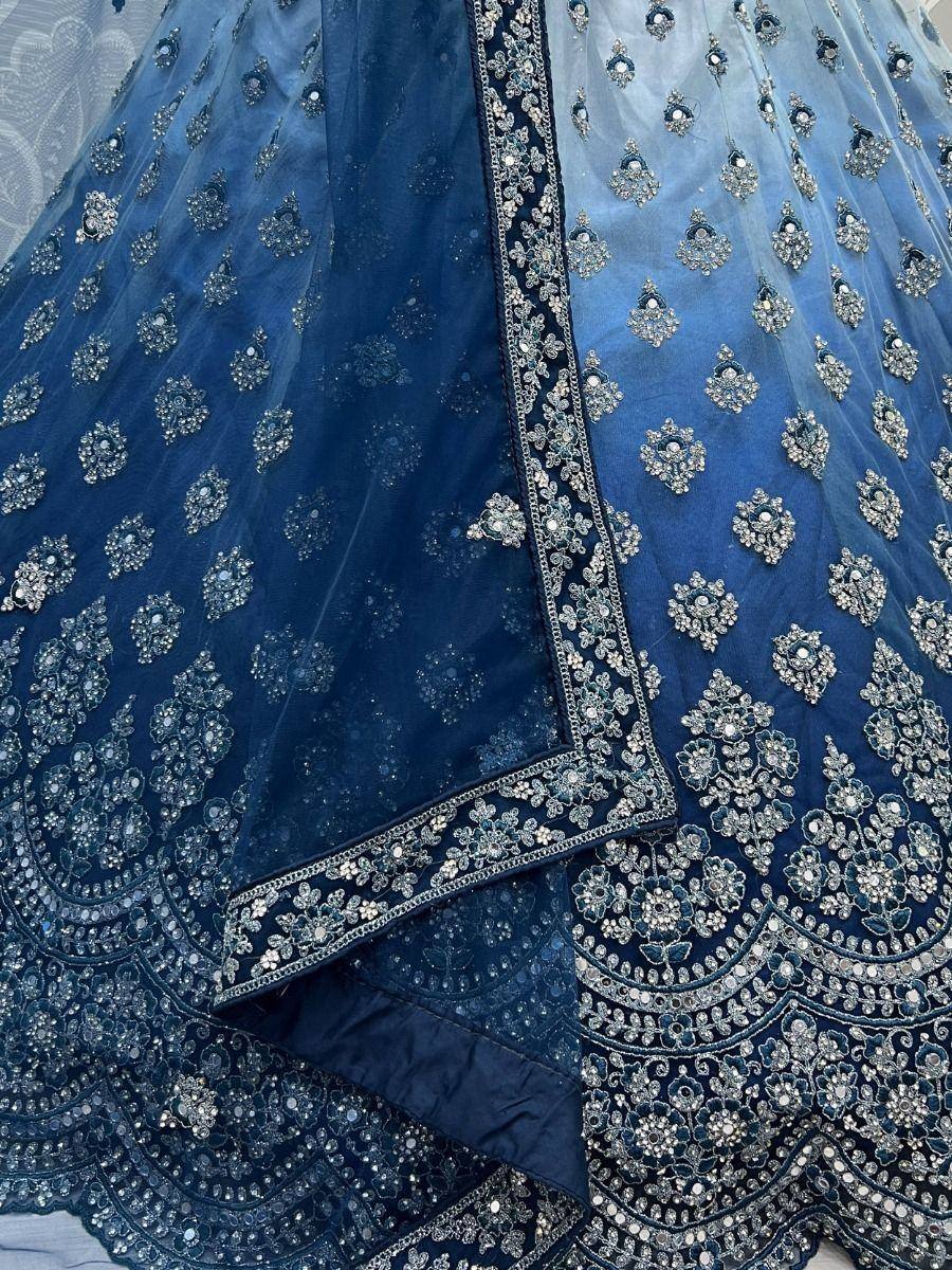 Blue designer lehenga choli with intricate silver embroidery and sequin work, perfect for Indian ethnic wear.