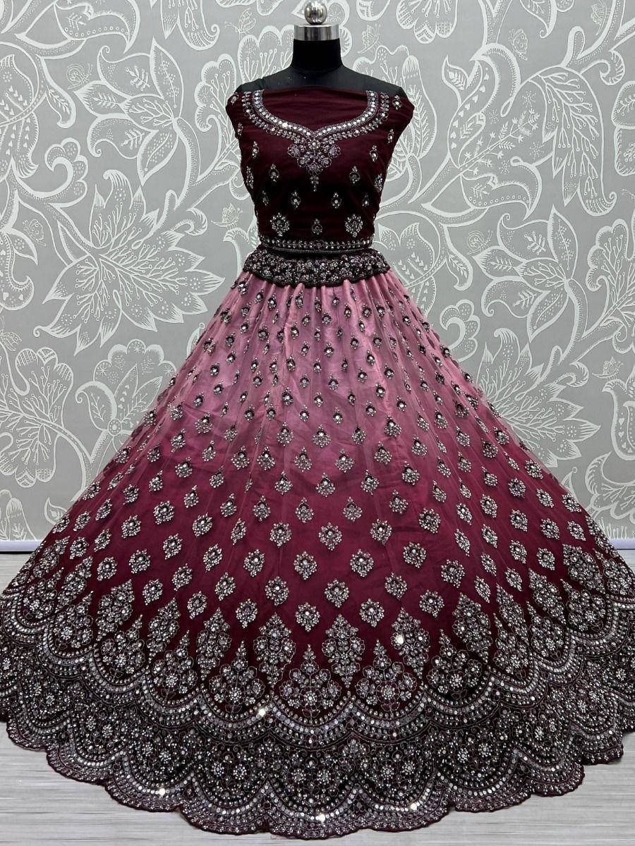 Maroon designer lehenga choli with heavy embroidery and sequins, perfect for weddings and festive occasions.