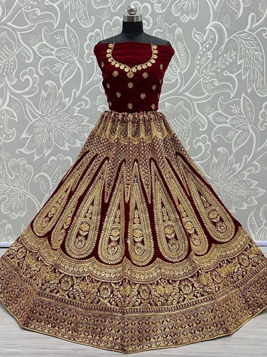 Maroon velvet lehenga choli with heavy gold embroidery, perfect for Indian weddings and festive occasions