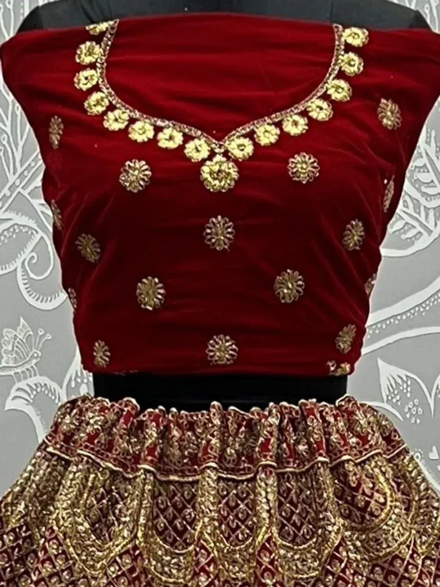 Red velvet lehenga choli with gold floral embroidery and detailed border work