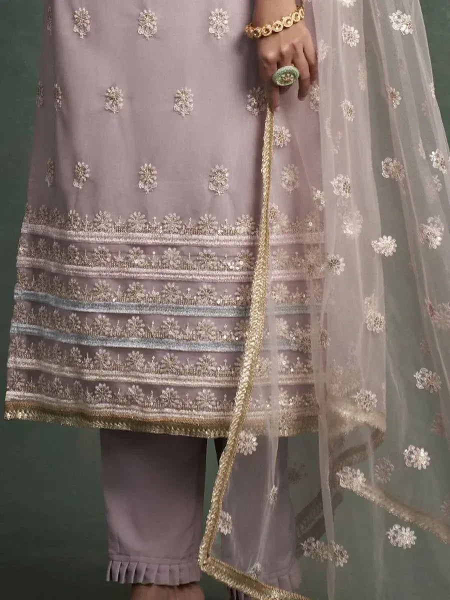 Elegant lavender salwar kameez with floral embroidery and gold trim, paired with sheer dupatta for ethnic wear.