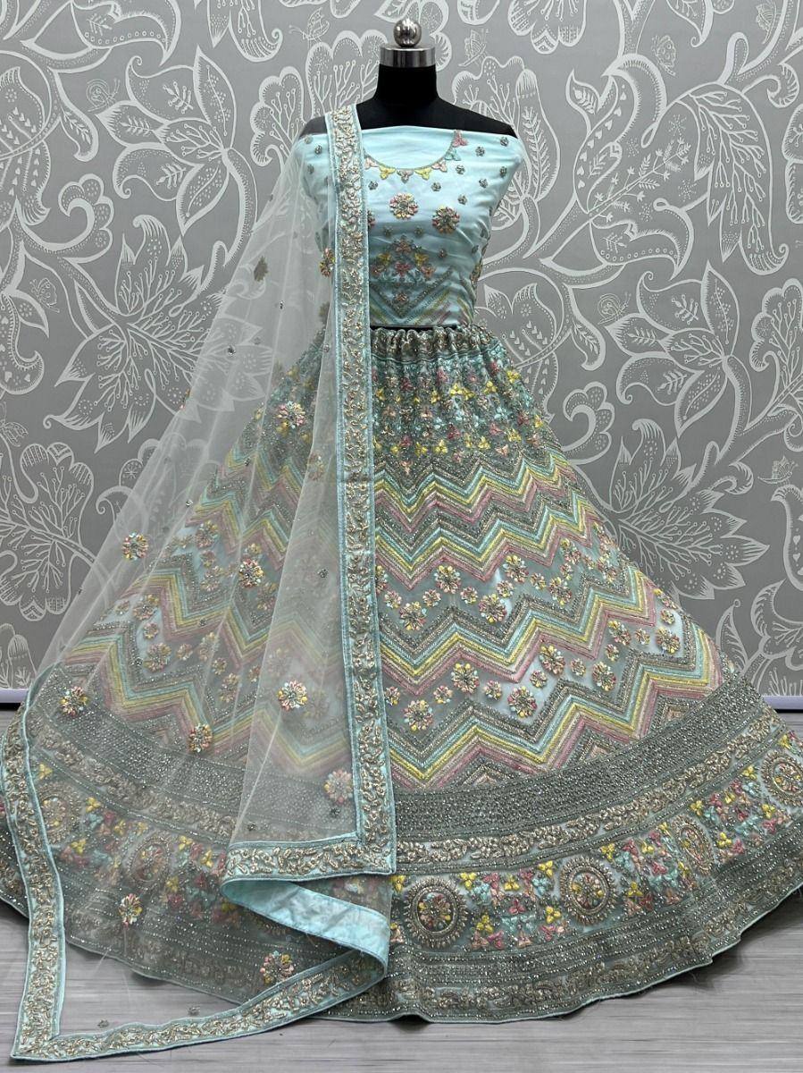 Light blue designer lehenga choli with floral embroidery and chevron patterns, paired with sheer dupatta