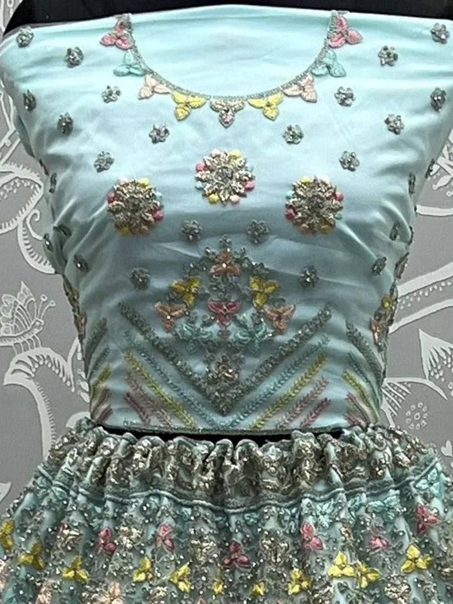 Light blue designer lehenga choli with floral and butterfly embroidery, perfect for ethnic occasions.