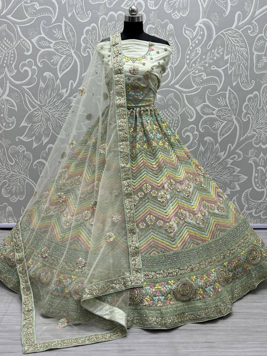 Pastel green designer lehenga choli with floral embroidery and chevron patterns, perfect for Indian ethnic wear.