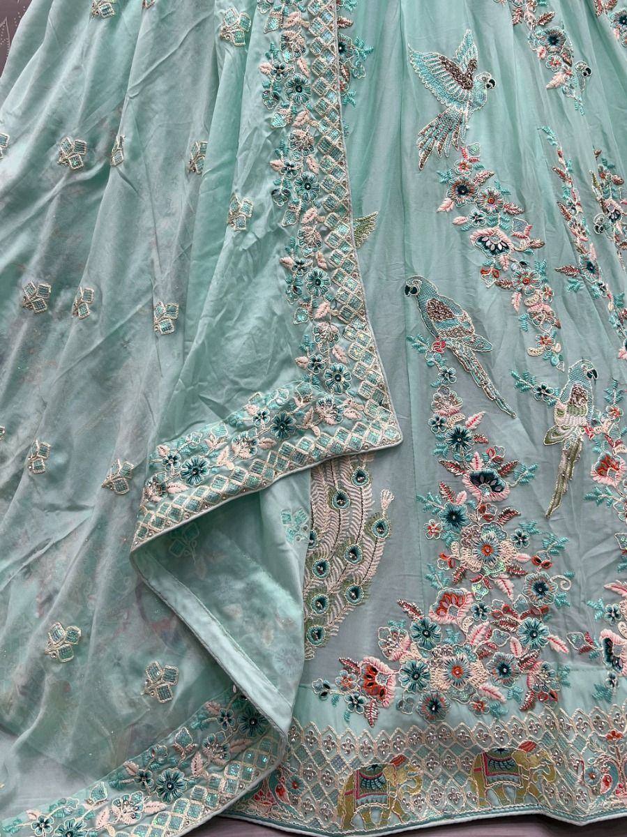 Mint green lehenga with floral and bird embroidery, perfect for Indian ethnic wear occasions