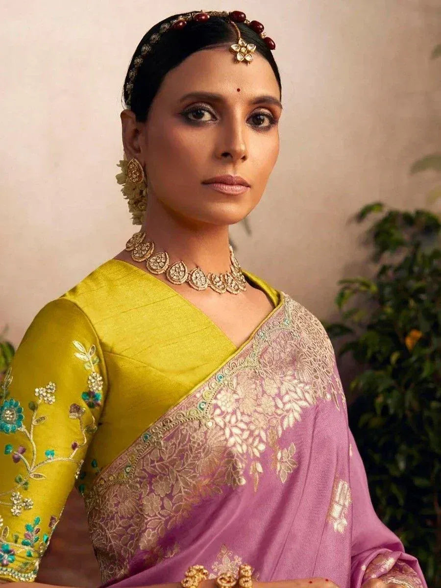 Woman in purple and yellow embroidered saree with gold jewelry, Indian ethnic wear