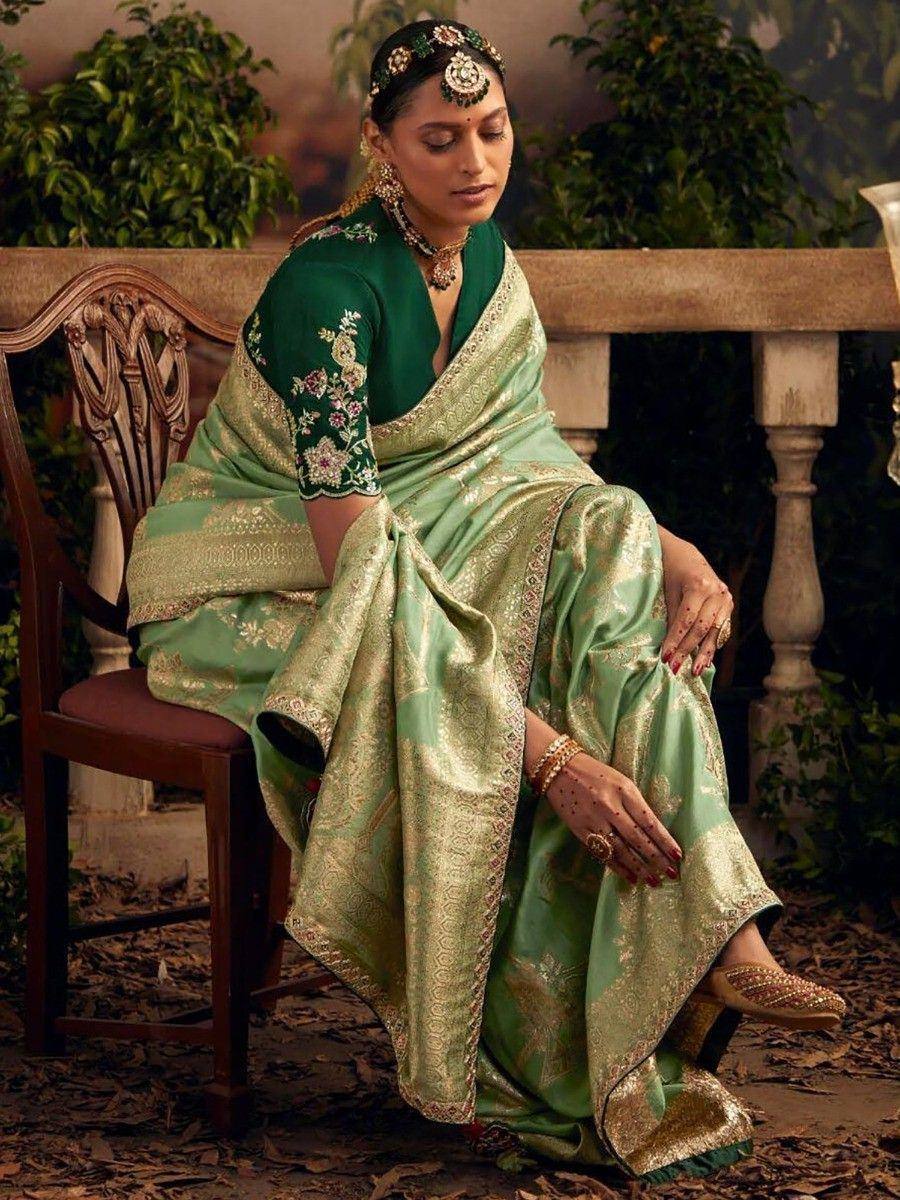 Elegant green saree with gold embroidery, floral blouse, and traditional jewelry for Indian ethnic wear