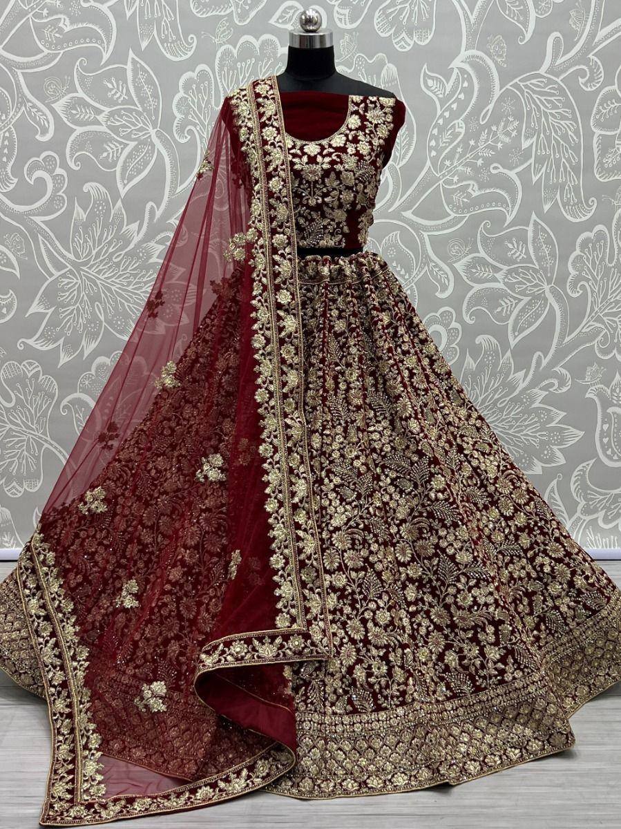 Maroon velvet lehenga choli with gold embroidery, perfect for Indian weddings and festive occasions.