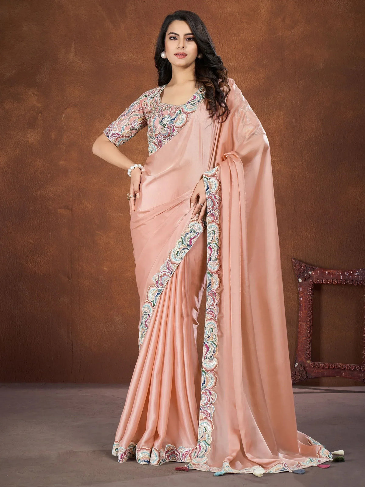 Elegant peach saree with floral embroidery, perfect for Indian ethnic occasions and festive wear.