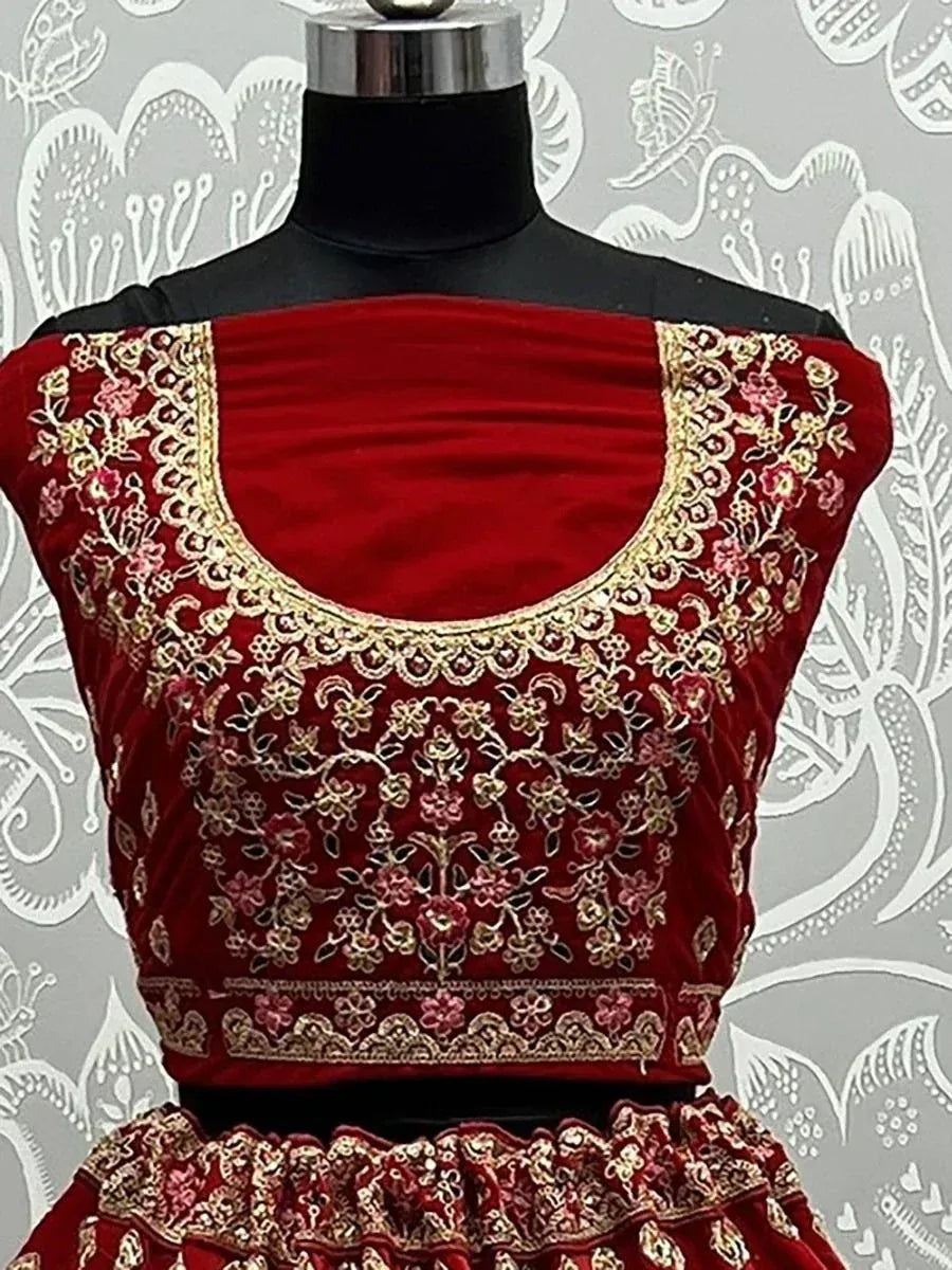 Red velvet lehenga choli with gold and pink floral embroidery, perfect for Indian ethnic wear occasions.