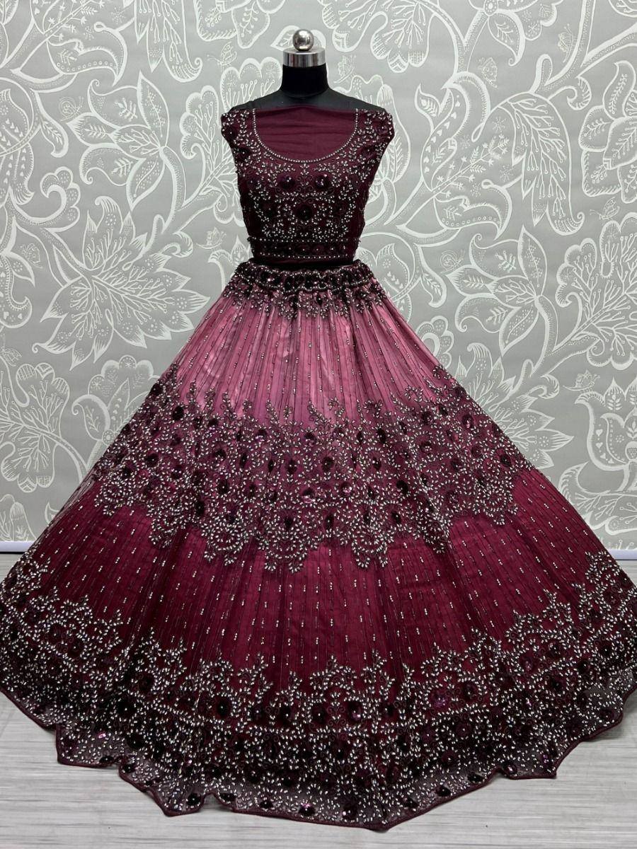 Burgundy designer lehenga choli with heavy embroidery and beadwork, perfect for weddings and festive occasions