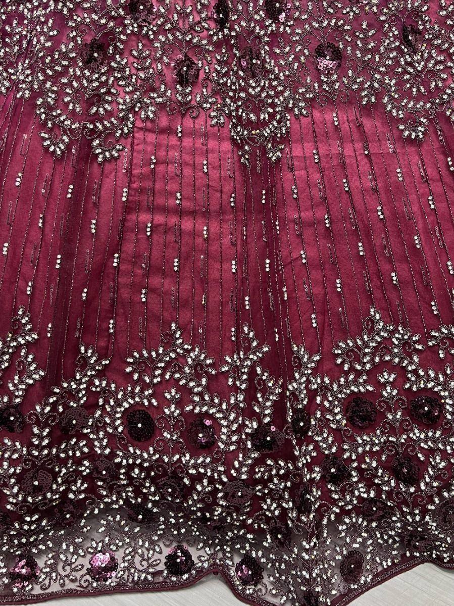 Maroon ethnic gown with intricate beadwork and sequin embroidery, perfect for Indian weddings and festive occasions.