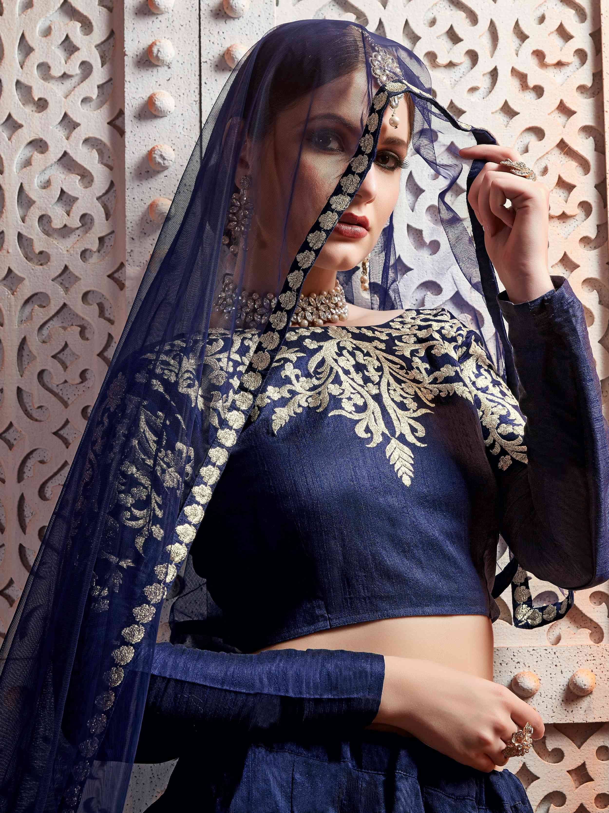 Navy blue ethnic crop top with gold embroidery and matching dupatta, styled with traditional jewelry
