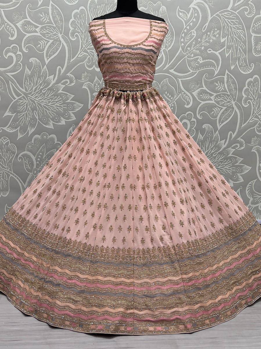Pink embroidered lehenga choli with gold motifs and striped border, perfect for Indian ethnic wear occasions