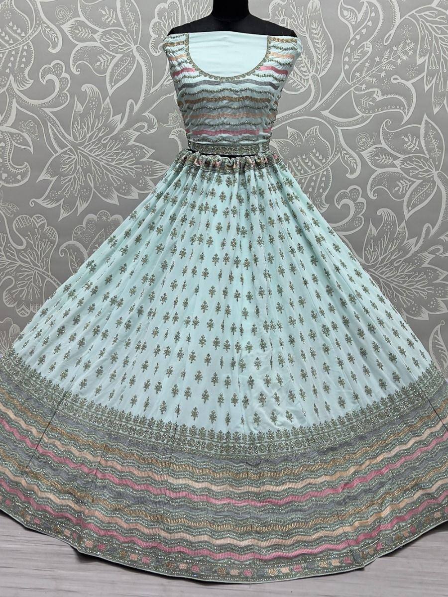 Mint green ethnic gown with floral embroidery and striped border, perfect for Indian occasions