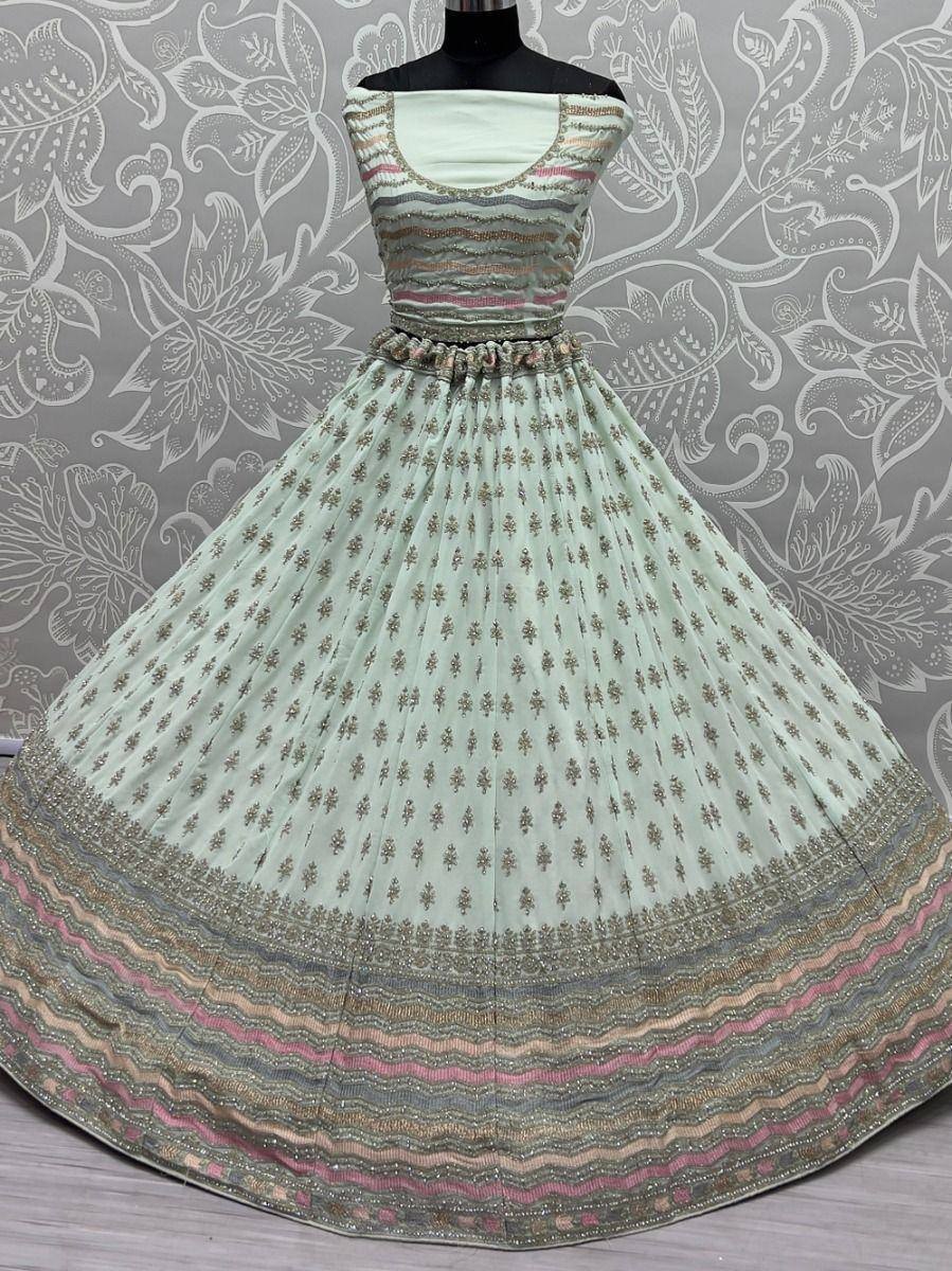 Mint green ethnic gown with gold embroidery and colorful border, perfect for Indian occasions