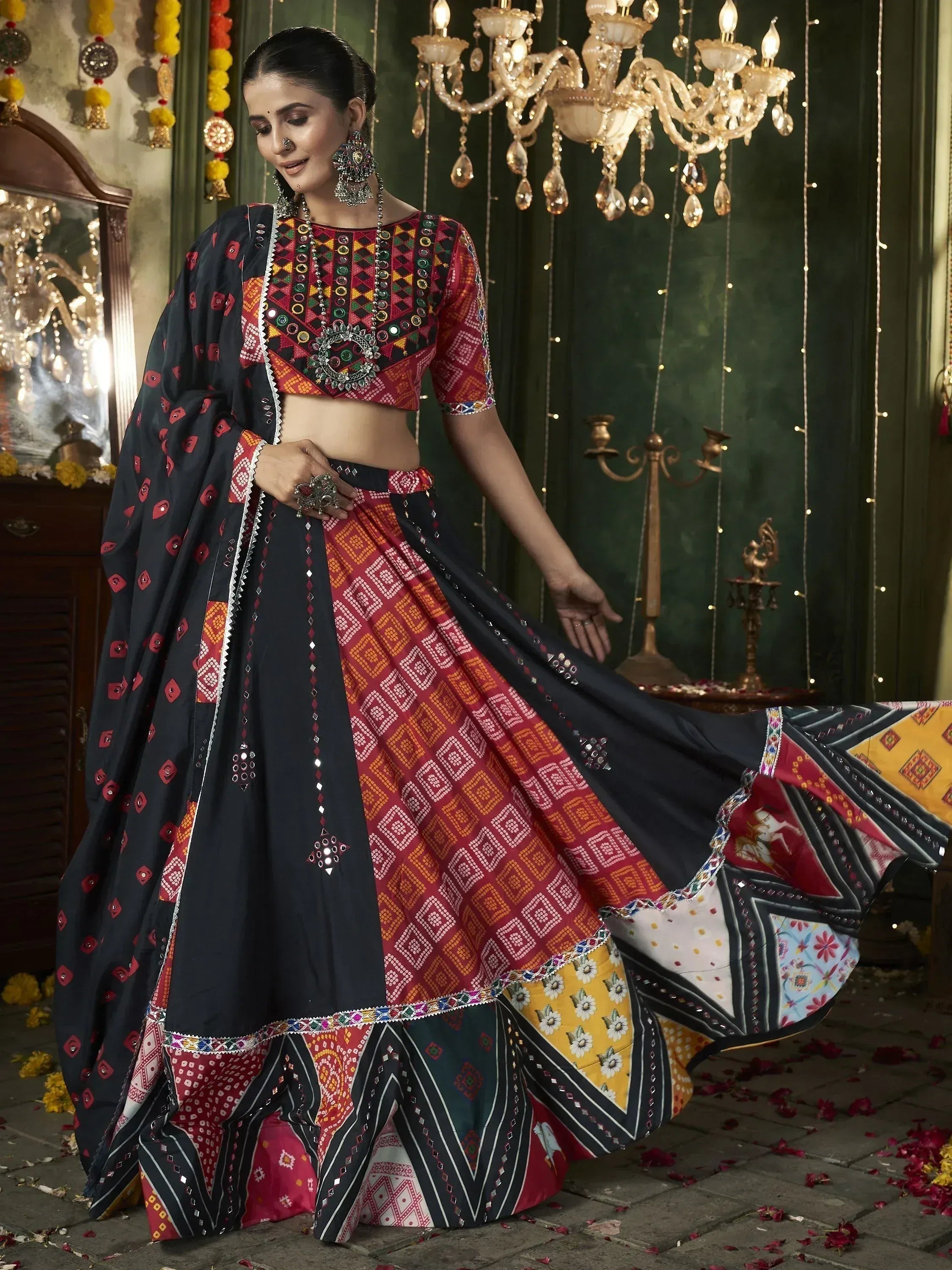 Woman in vibrant ethnic lehenga choli with mirror work, geometric prints, and colorful dupatta, perfect for Indian festive occasions.
