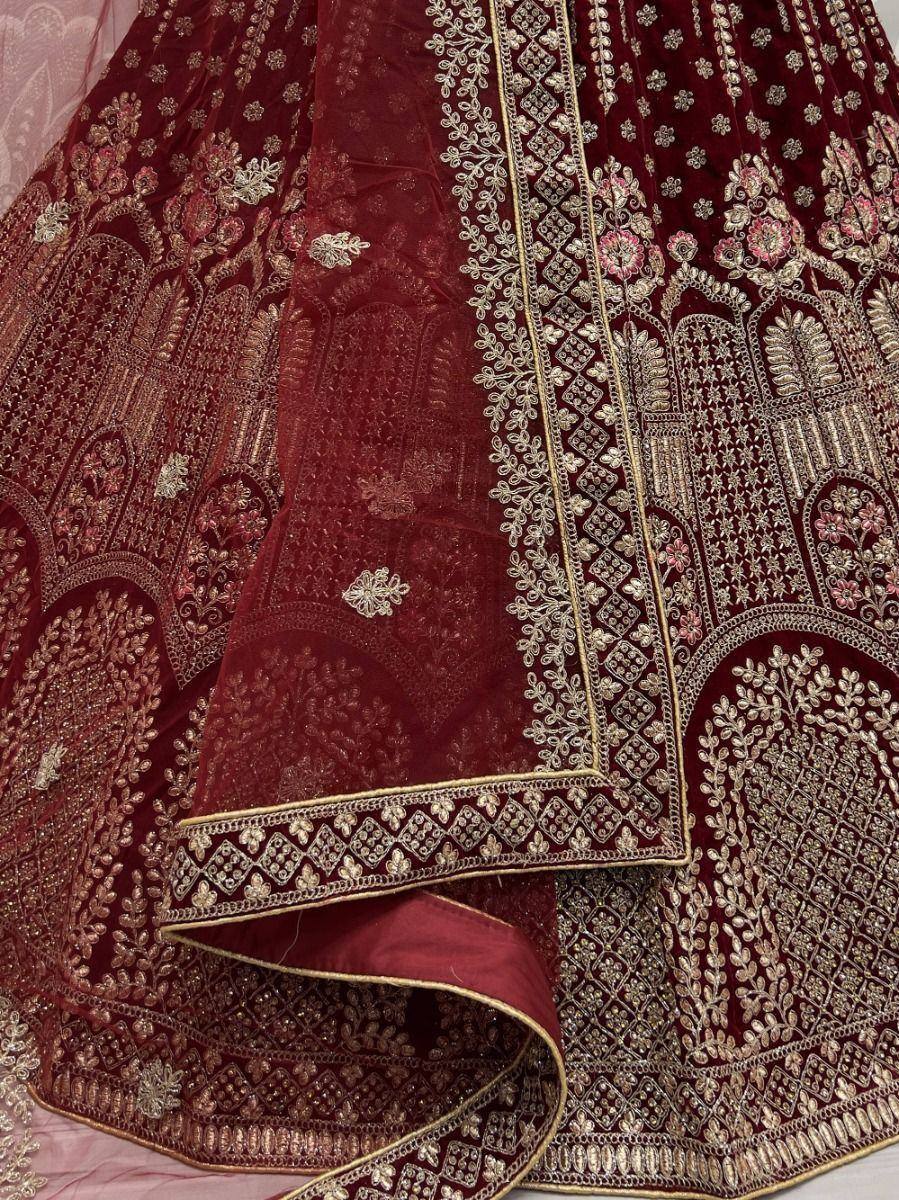 Maroon velvet lehenga choli with gold floral embroidery and intricate border detailing