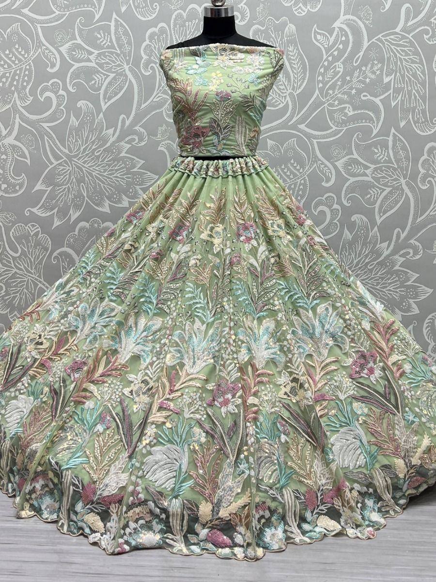 Mint green embroidered ethnic gown with floral design, perfect for Indian weddings and festive occasions.
