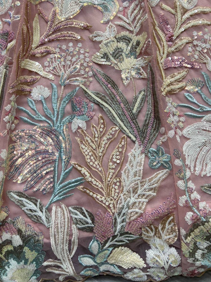 Intricate floral embroidery with sequins on soft pink ethnic wear fabric, perfect for designer lehenga or saree.