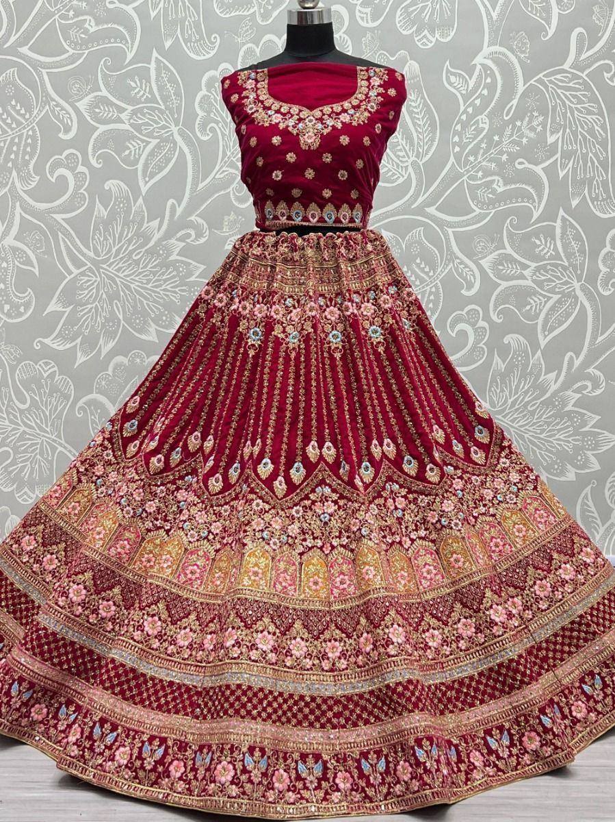 Maroon velvet lehenga choli with heavy floral embroidery, perfect for Indian weddings and festive occasions.