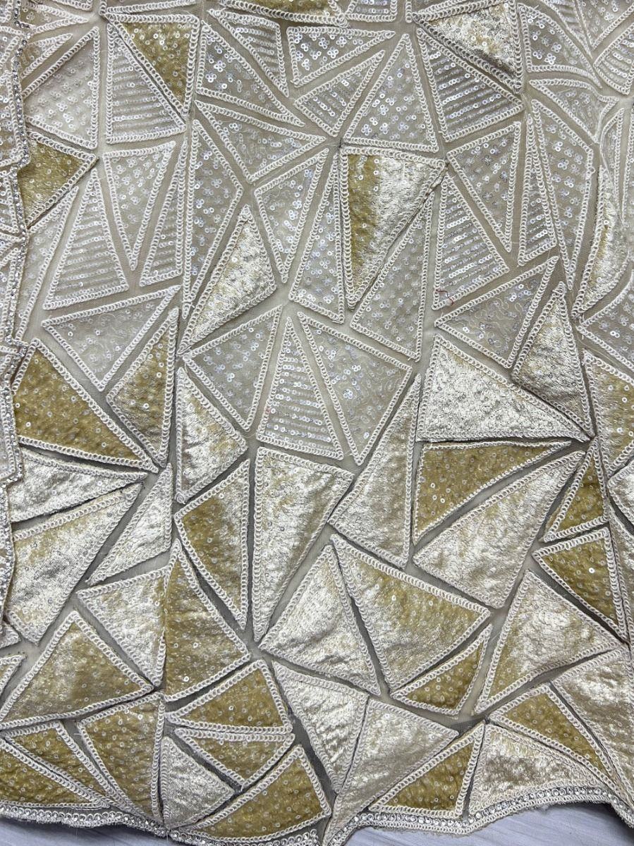 Fascinating Beige Sequins Embroidered Net Lehenga Choli