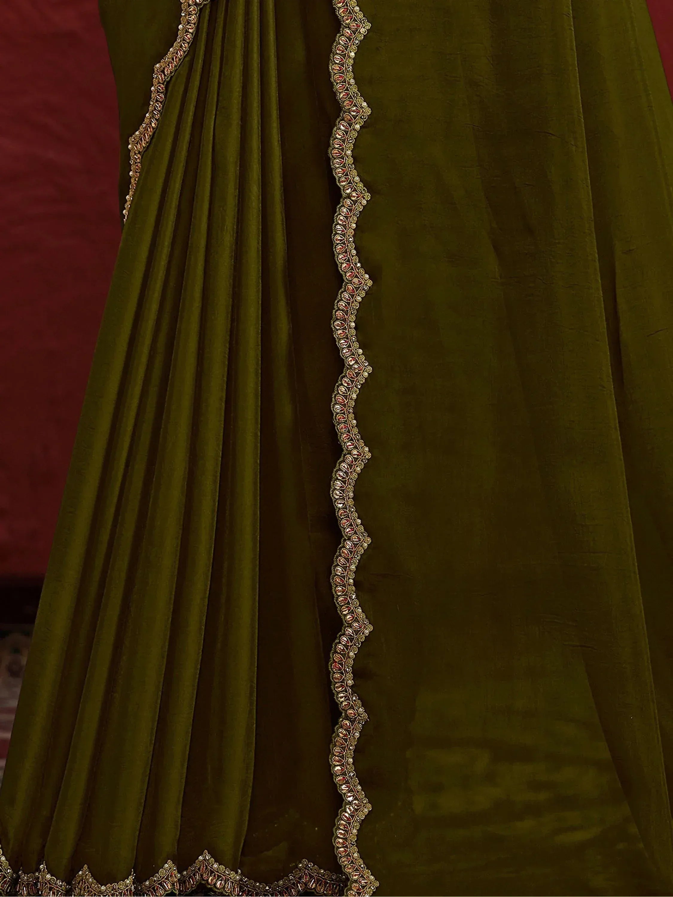 Olive green velvet ethnic gown with intricate gold and red embroidery detailing