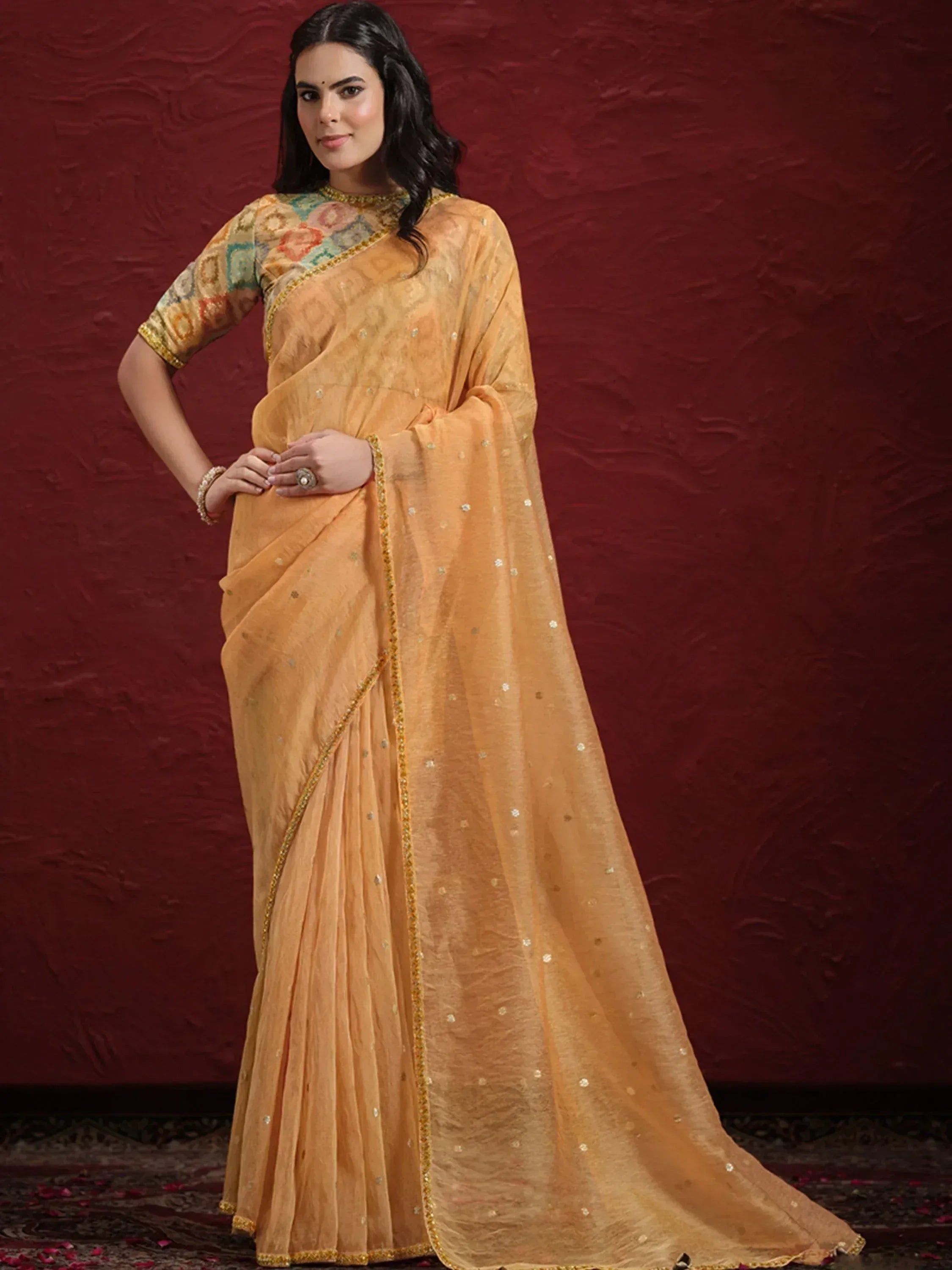 Elegant mustard yellow saree with golden embroidery and sequins, paired with a printed blouse