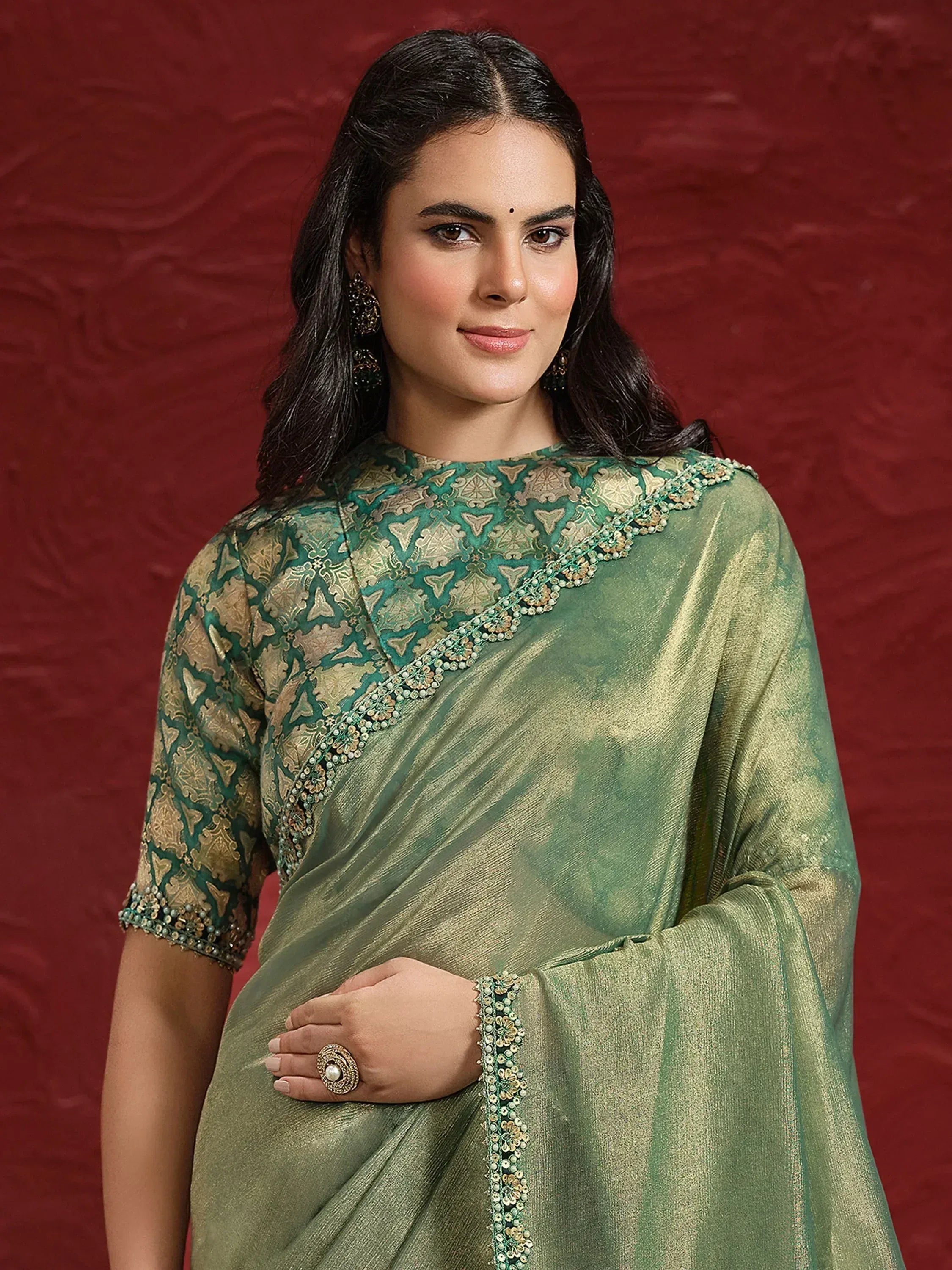 Elegant green and gold embroidered saree with designer blouse, perfect for Indian ethnic occasions