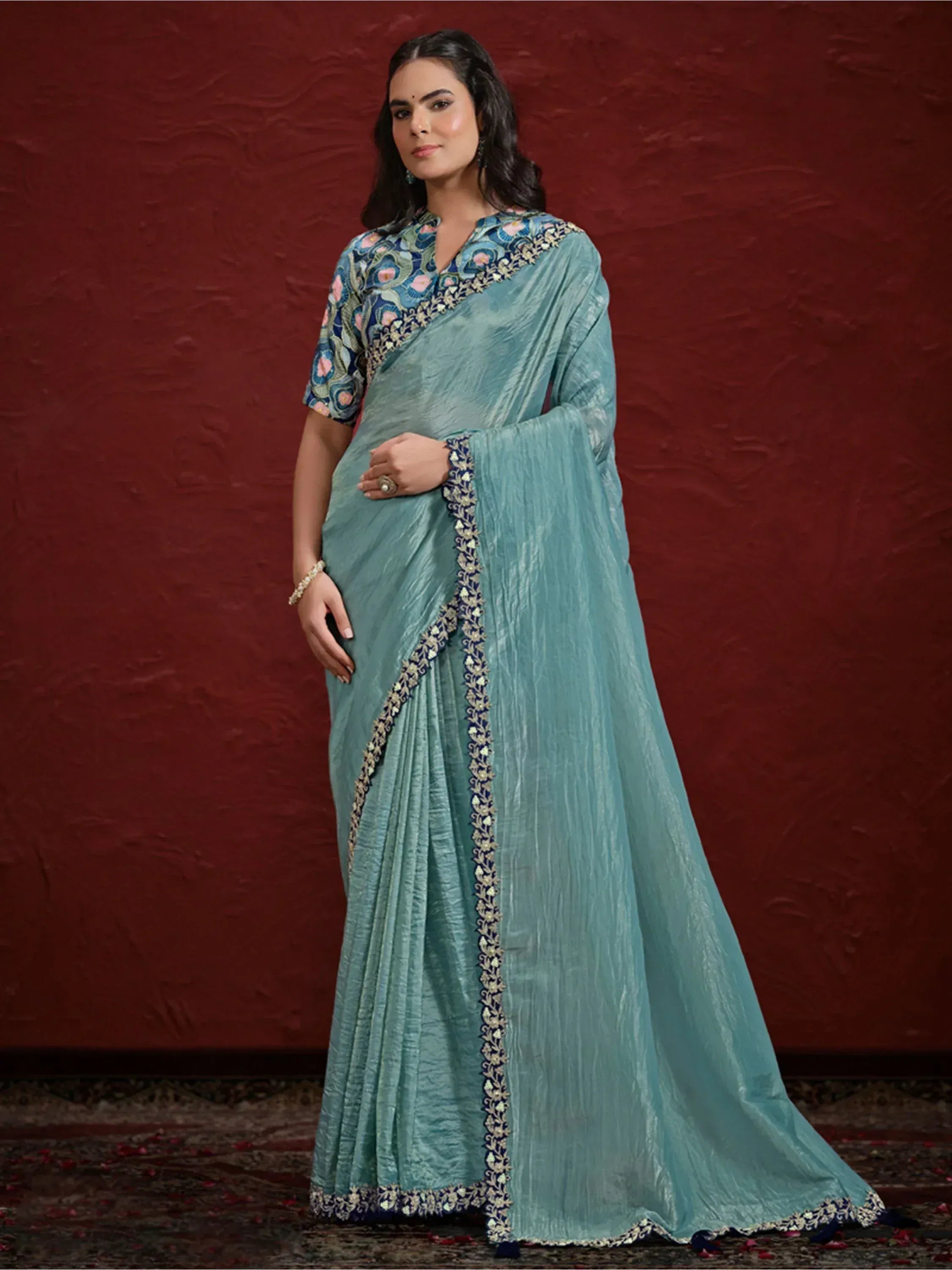 Elegant teal saree with floral embroidery and contrasting border, perfect for Indian ethnic occasions