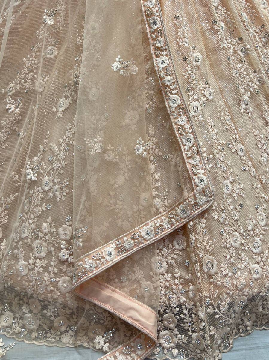 Elegant beige lehenga with floral embroidery and sequin detailing, perfect for Indian ethnic wear