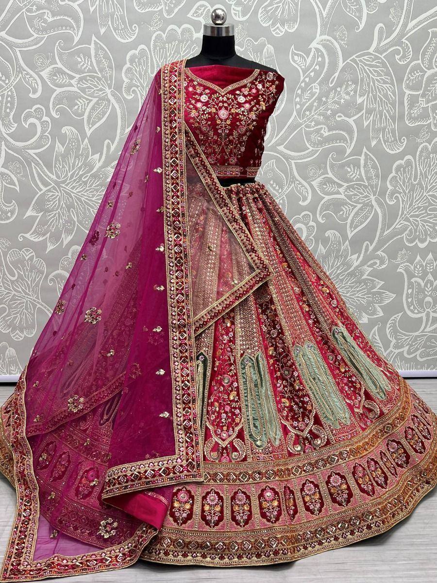 Maroon designer lehenga choli with heavy embroidery and matching dupatta, ideal for weddings and festive occasions.